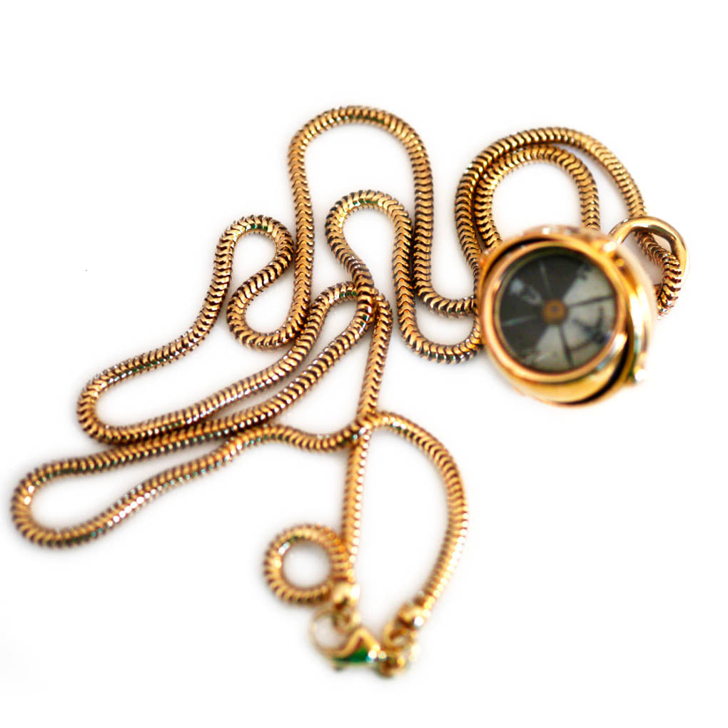 Antique Articulated Gold Gimbal Orb Compass Pendant on a gold chain photographed on a white background