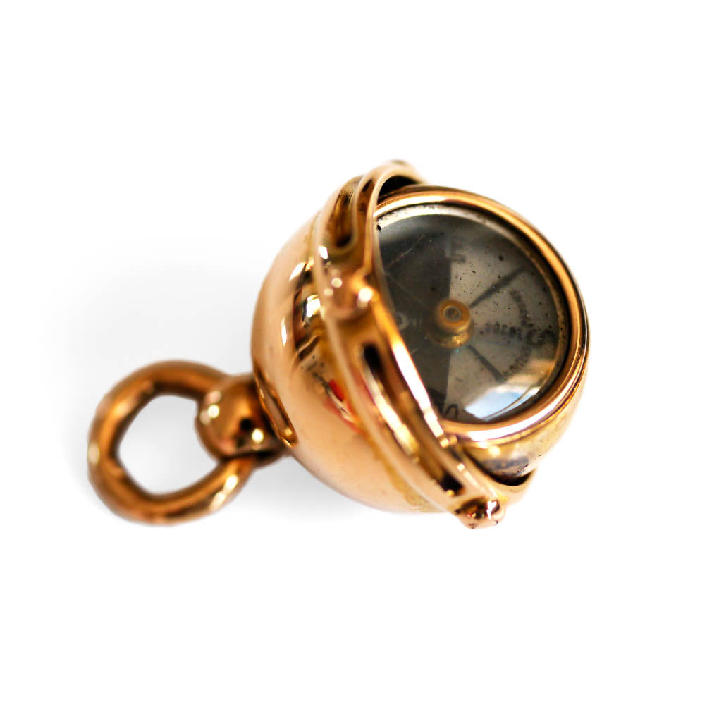 Antique Articulated Gold Gimbal Orb Compass Pendant photographed on a white background