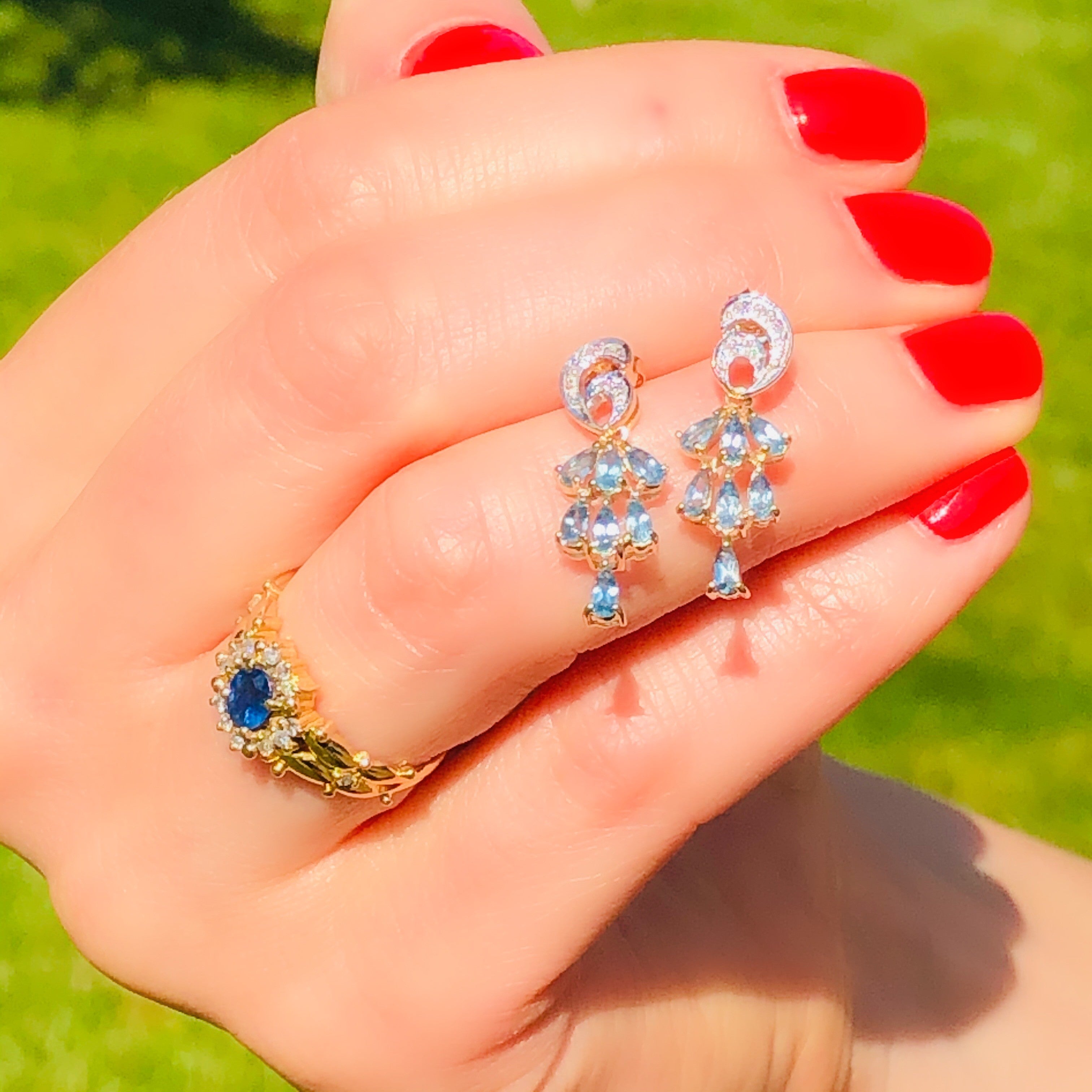 Blue Sapphire & Diamond Cocktail Vintage Earrings held by model with red painted fingernails