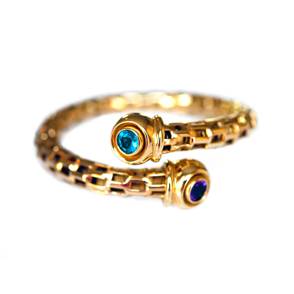 Alluring Amethyst & Topaz Torque Bangle photographed on a white background
