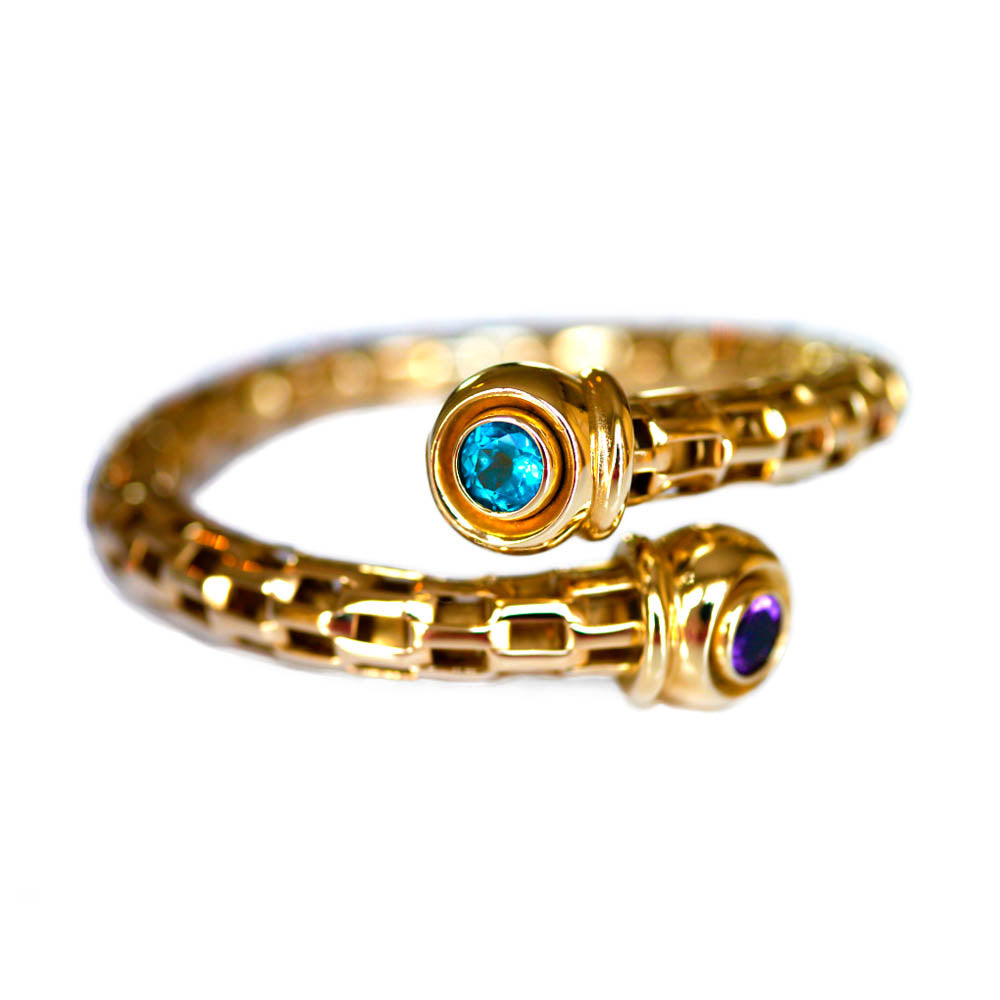 Alluring Amethyst & Topaz Torque Bangle photographed on a white background