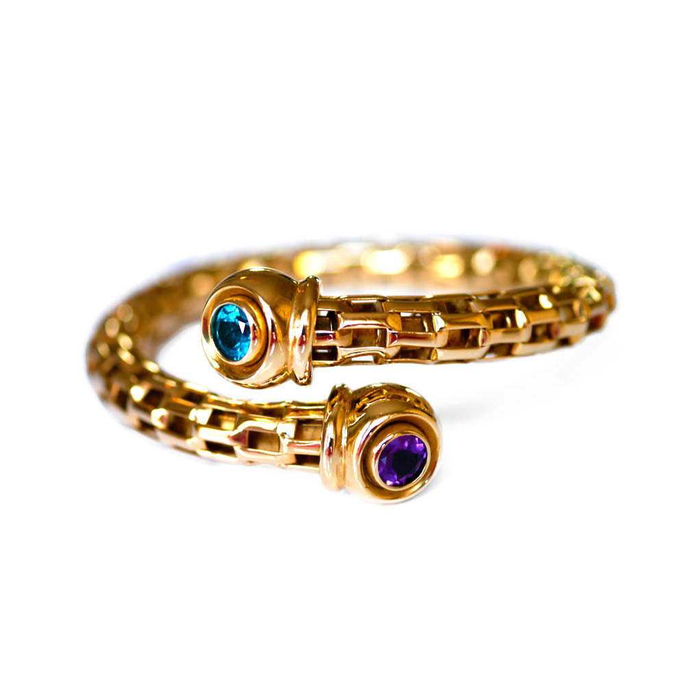Alluring Amethyst & Topaz Torque Bangle photographed on a white background