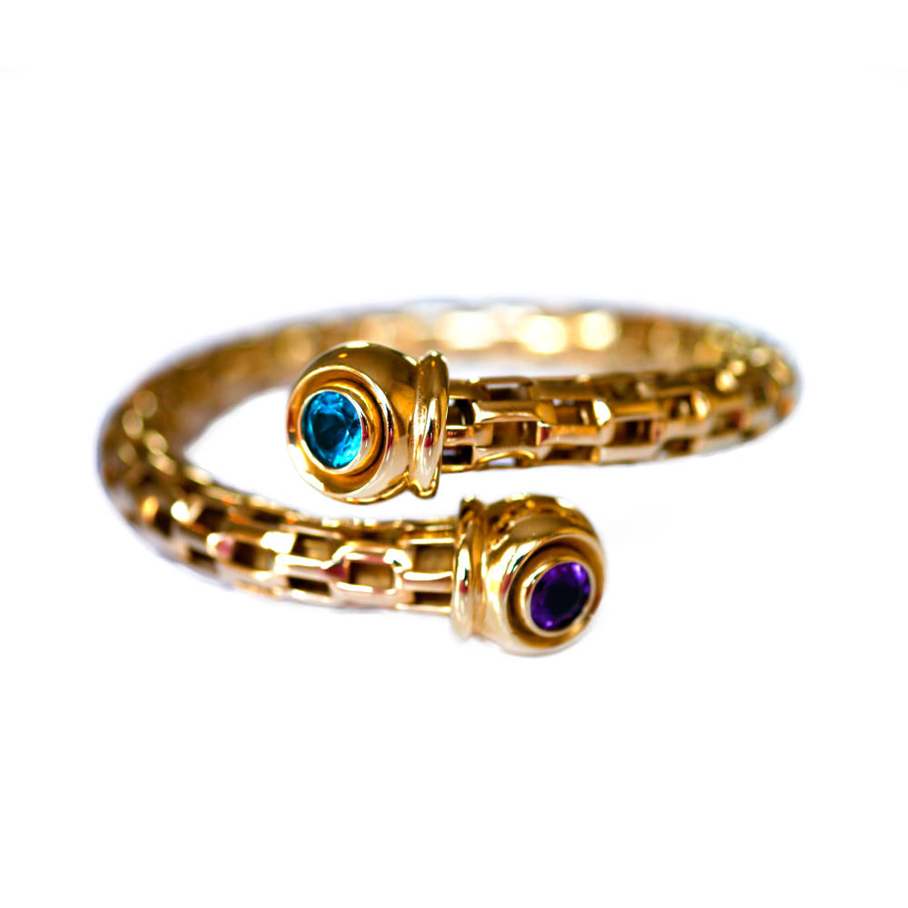 Alluring Amethyst & Topaz Torque Bangle photographed on a white background