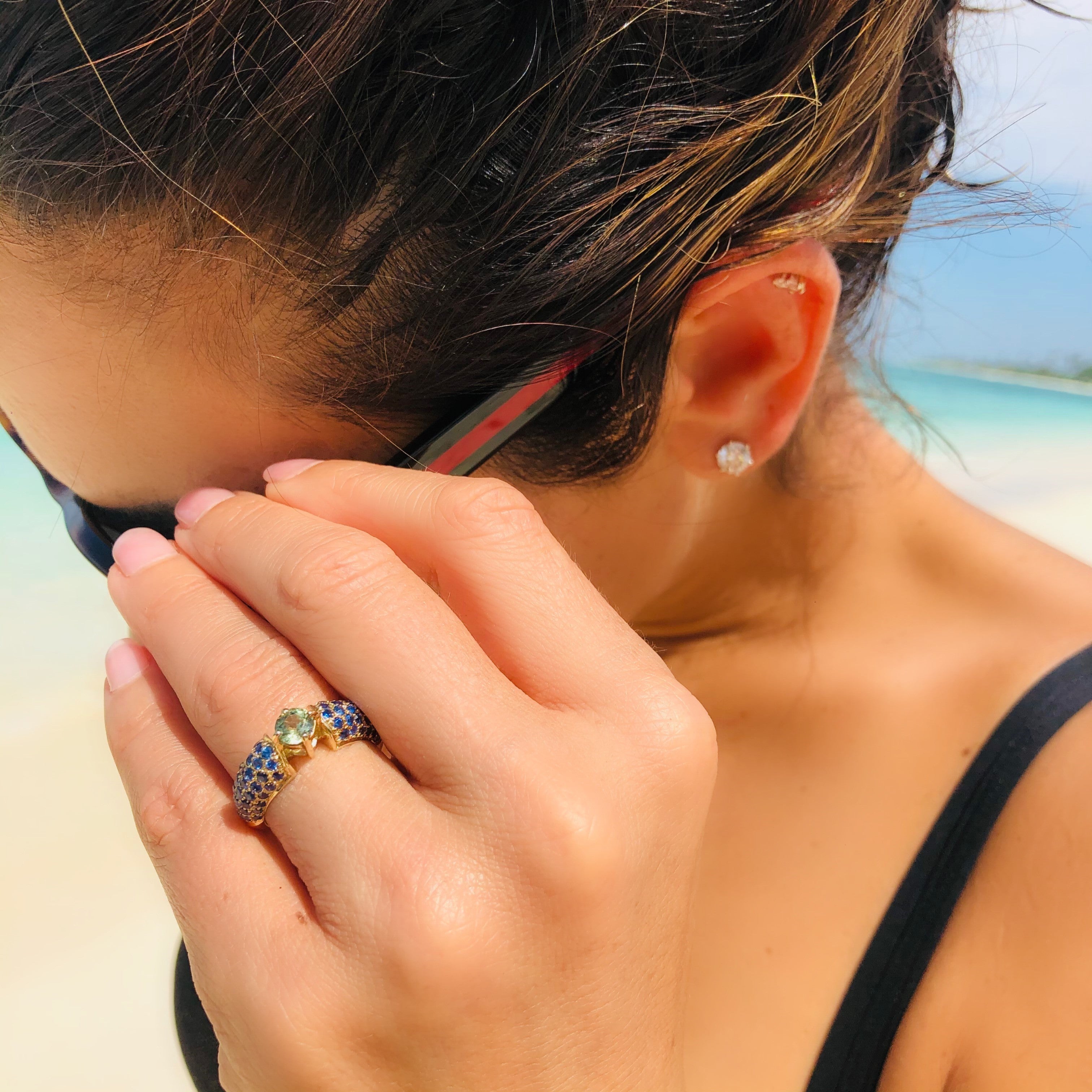 Blue and Green Sapphire Ring photographed on models ring finger