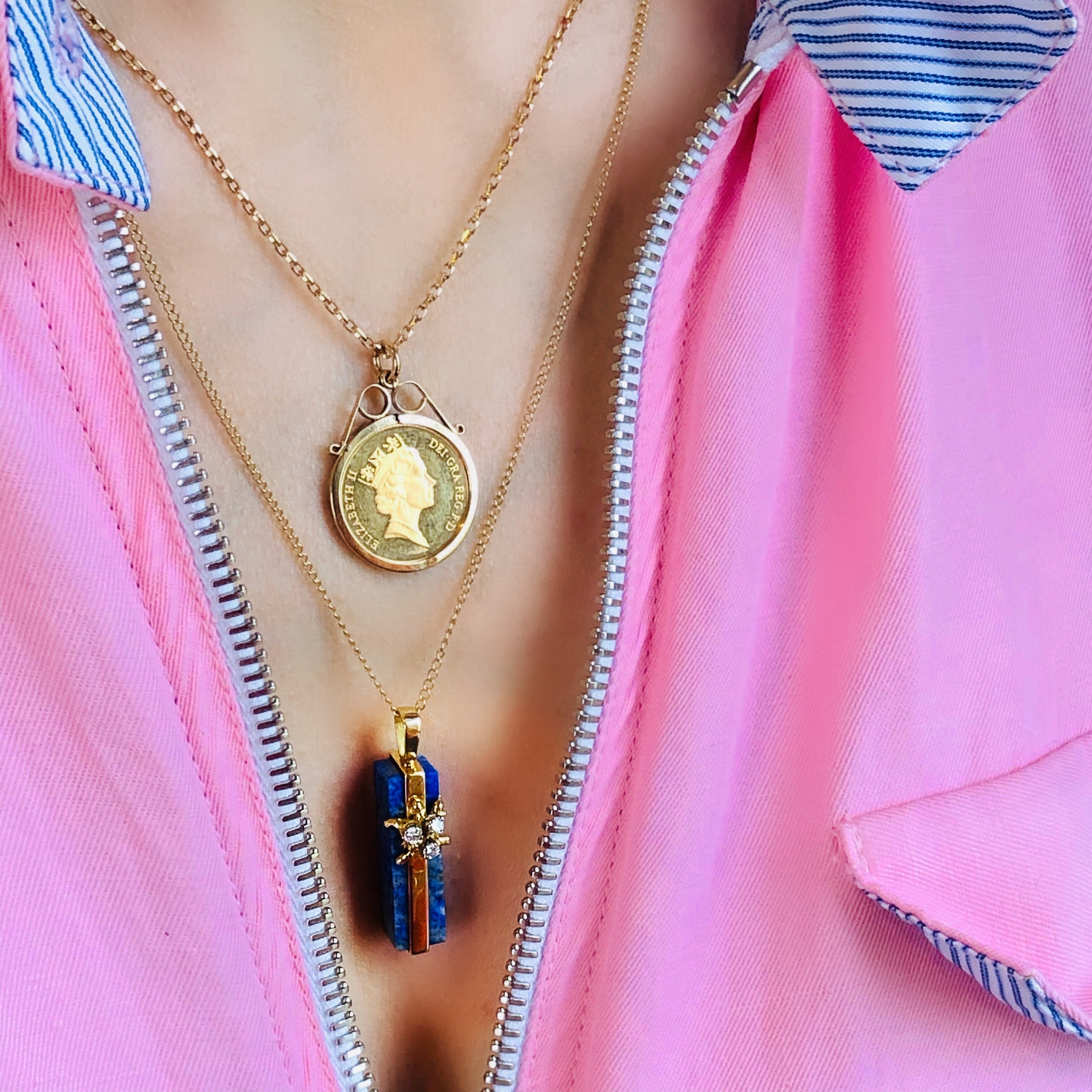 1975 Dazzling Diamond and Lapis Lazuli Necklace photographed with another necklace on a model wearing a pink shirt