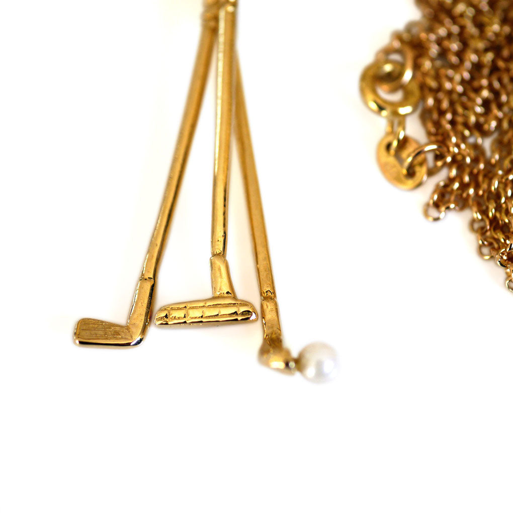 1973 Gold & Pearl Golf Clubs Necklace photographed on a white background