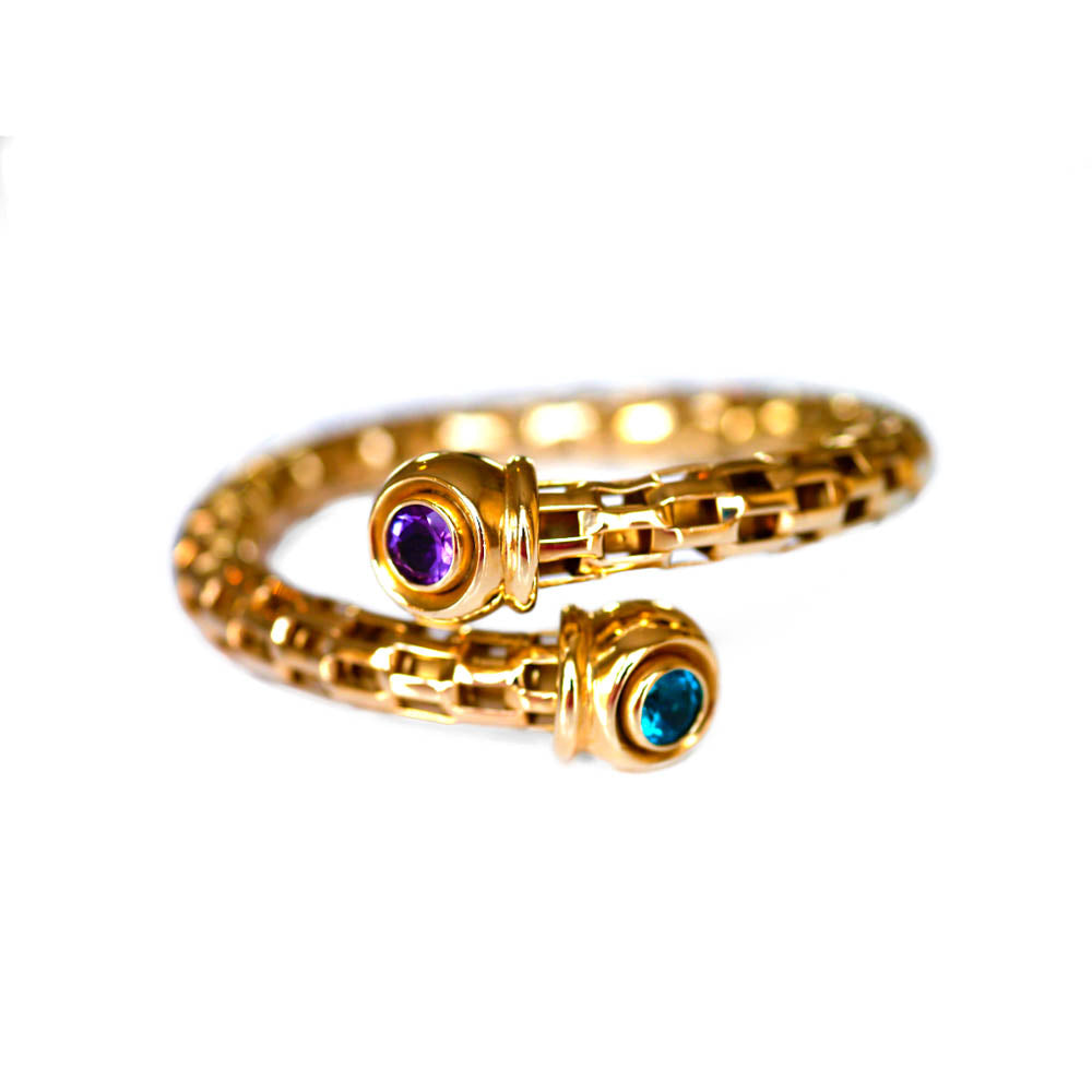 Alluring Amethyst & Topaz Torque Bangle photographed on a white background