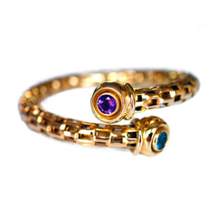 Alluring Amethyst & Topaz Torque Bangle photographed on a white background