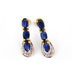 Blue Sapphire and Diamond Earrings photographed on a white background
