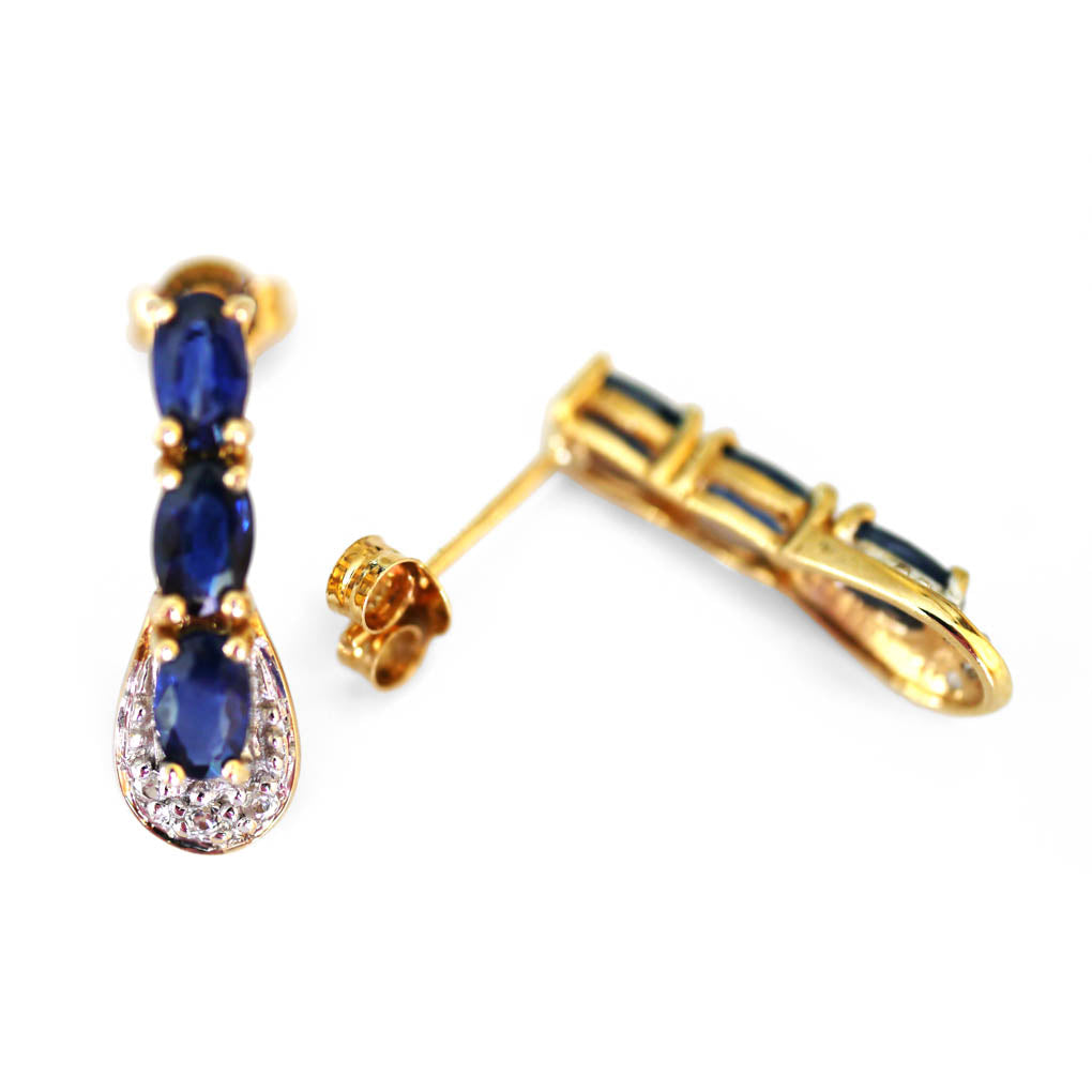 Blue Sapphire and Diamond Earrings photographed on a white background