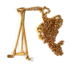 1973 Gold & Pearl Golf Clubs Necklace photographed on a white background